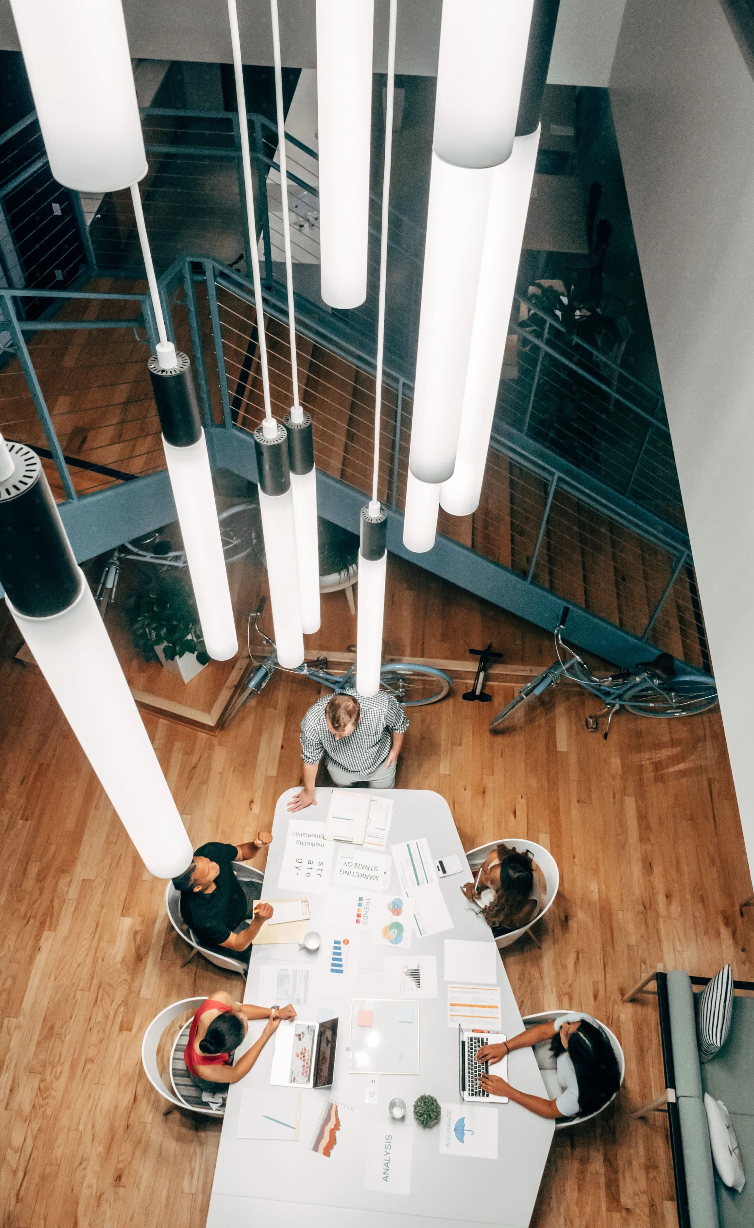 Team collaborating around a long table in a bright office